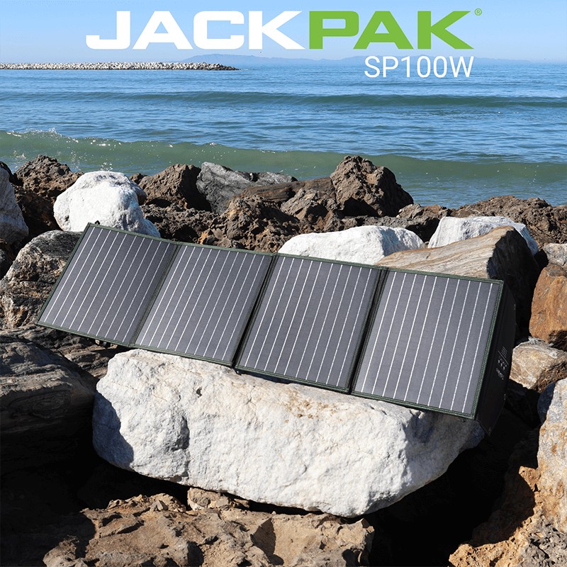 JackPak SP100W foldable solar panels with a kickstand, charging devices near the ocean.